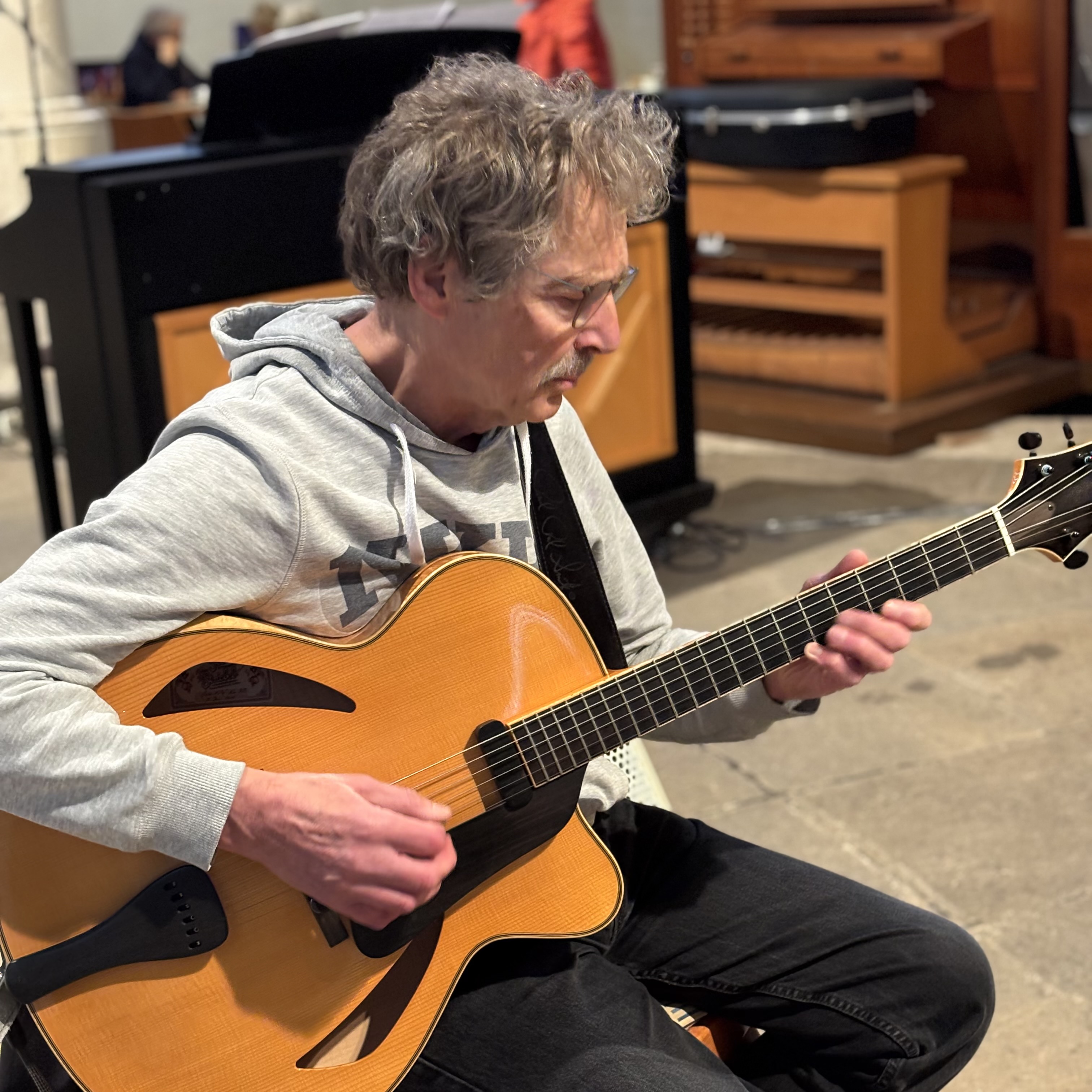 Mann spielt Akustikgitarre